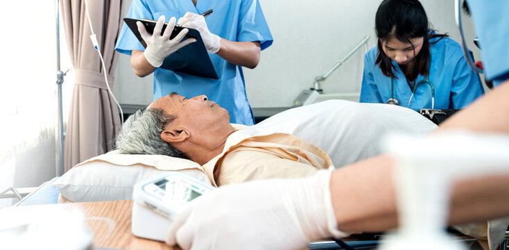 asian Nurse with elderly patient in the intensive care unit ,Unconscious senior man lying in a hospital bed