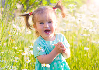 little beautiful child girl in daisies flowers field summer bright  mood  positive