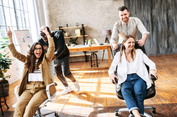 Fun corporate games of young multiracial team in cosy office. A friendly informal atmosphere of young team in the office