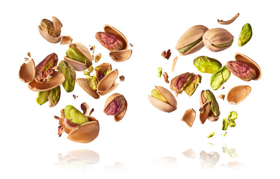 A set with Flying in air fresh raw whole and cracked pistachios  isolated on white background. Concept of Pistachios is torn to pieces close-up. High resolution image