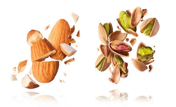 A set with Flying in air fresh raw whole and cracked pistachios and almonds isolated on white background. Concept of Pistachios is torn to pieces close-up. High resolution image