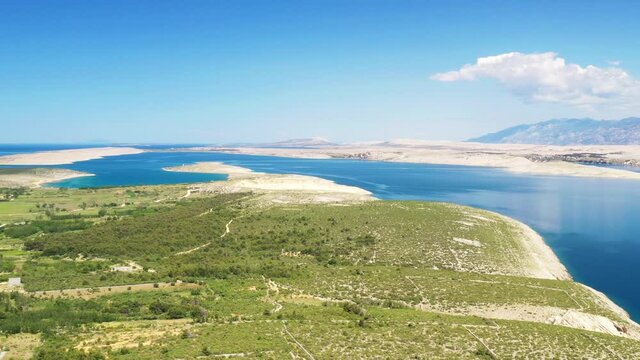 Croatia, Adriatic coastline in Vrsi, stone desert and view of the Pag island and Velebit mountain in background
