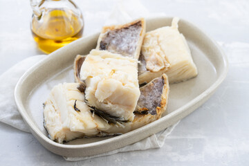 boiled cod fish on dish on ceramic background