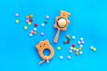 Children flat lay with toys and candy on blue background top view