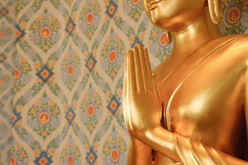 Close up of hands of golden Buddha statue copyspace