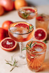 Summer cocktail with blood orange, grapefruit and rosemary