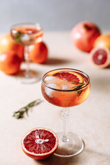 Summer cocktail with blood orange, grapefruit and rosemary