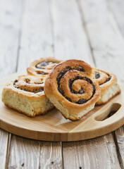 Tasty buns with raisins on a brown rustic wooden table. fresh bakery. breakfast. bread. top view