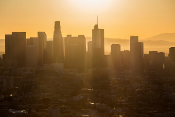 Morning aerial view of sunshine beaming through downtown towers in Los Angeles, California.