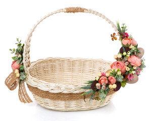 Fototapeta na wymiar Very beautiful original wicker basket decorated with pink roses and greenery. Around the basket is a sack tape.