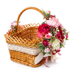 Fototapeta na wymiar Very beautiful original brown wicker basket decorated with pink and white peonies. Ribbons and lace.