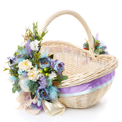 Fototapeta na wymiar Brown wicker basket with floral decoration, decorative wooden bunny and ribbons on white background. The basket is decorated in in pastel colors before Easter.