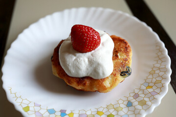 Cheese pancake with sour cream and strawberry