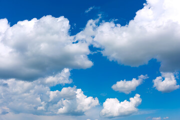 White clouds on blue sky background.