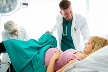 Pregnant woman with doctor in maternity hospital before childbirth