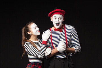 a man and a woman with white makeup on their faces like mimes  with funny emotions isolated on...