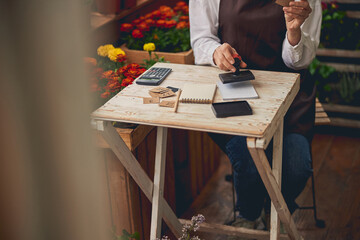 Woman in work clothes sitting at the table