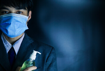 Businessman with mask and bottle of hand sanitizer