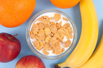 Healthy eating breakfast bowl of low calories muesli with fruits and milk