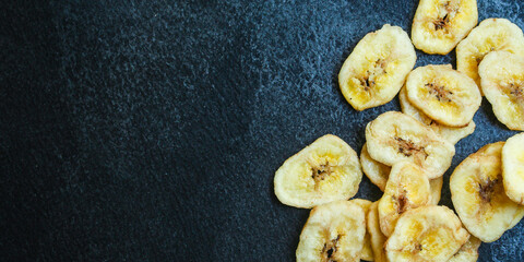 banana chips sweet and healthy snack Menu concept serving size. food background top view copy space for text