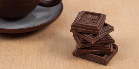 Chocolate and cup of coffee espresso on wood background