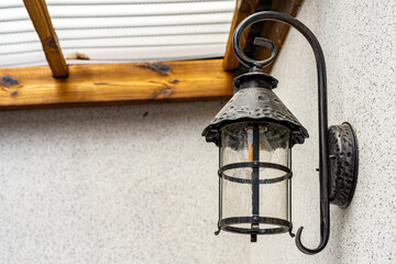Lamp in vintage style. The lamp is attached to the wall. The lamp is black