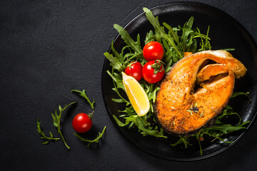 Salmon fish with fresh salad.