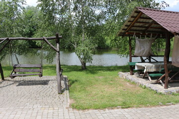 The recreation center in ethno style is a favorite vacation spot in Ukraine. Children and adults love to ride wooden swings.