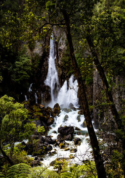 Famous hole in the rock Tarawera Falls flowing out of the cliff face near the lake tarawera outlet camp ground