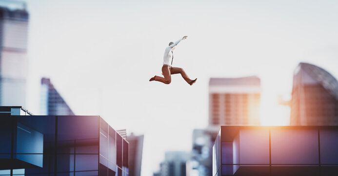 Man jumping between skyscrapers. Business success