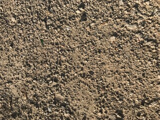 background texture of a dirt road from the ground clay and stones