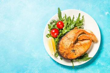 Salmon fish with fresh salad.