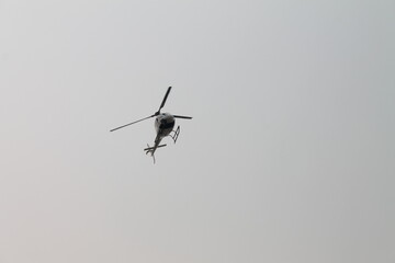 A helicopter hovering in the air 