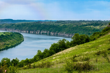 Fototapeta na wymiar Colorful landscape with high Ukrainian mountains, beautiful river, green forest, rainbow. Mountain river. Travel in Ukraine