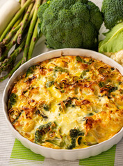 Broccoli, cauliflower and asparagus casserole with eggs and cheese, keto diet dish.