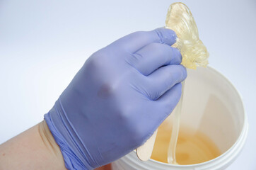 Sugar paste for hair removal in a bucket