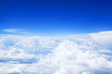 White cumulus clouds clear blue sky background, scenic aerial cloudscape view from airplane, high azure skies backdrop, fluffy cloud texture, sunny heaven, cloudy weather, flight landscape, copy space