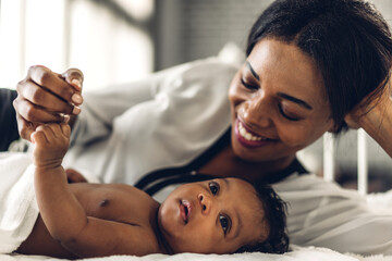 Portrait of enjoy happy love family african american mother playing with adorable little african...