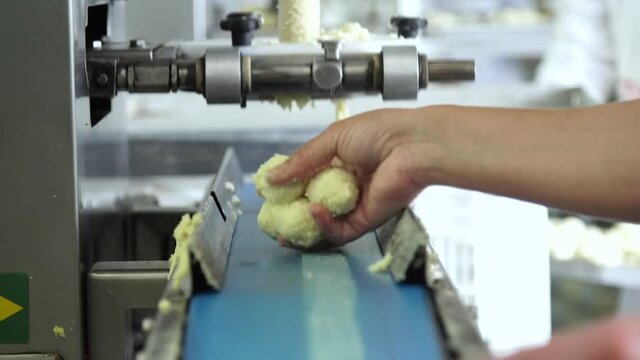 Cheese bread maker, Brazilian snack, traditional cheese bread from Minas Gerais - pao de queijo
