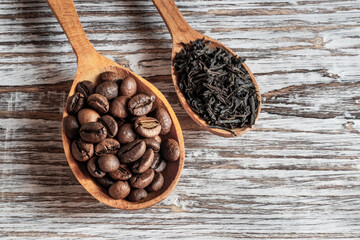Coffee beans and tea in wooden spoons
