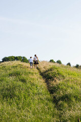 running children in the field in early summer morning