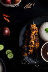 Chicken satay skewers with rice and peanut dipping sauce