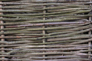 Woven wood fence in village or country house. Rustic style