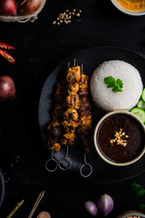 Chicken satay skewers with rice and peanut dipping sauce