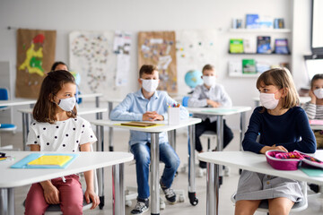 Children with face mask back at school after covid-19 quarantine and lockdown.