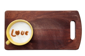 Top view of a cup of coffee with cream decorated. Food art creative concept image, drawing with cinnamon powder over wooden background.