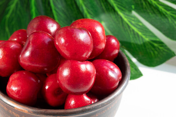 Fresh ripe cherry on plate on white background. Red sweet cherries