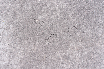 Smooth surface of grey ground with cracks during drought as background or texture