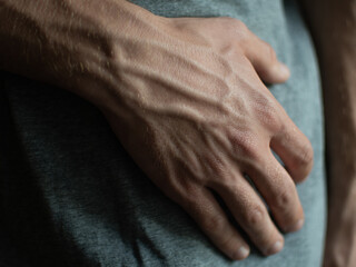tanned hands with protruding vessels of a young guy. sexy hands