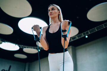 Confident blonde woman pulling elastic band